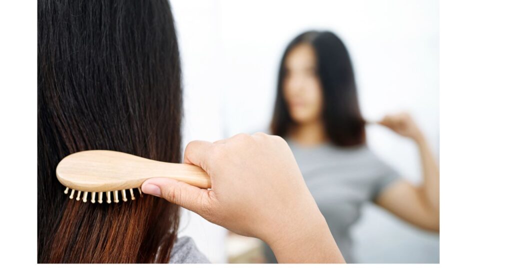 分け目を変えてヘアセットする女性
